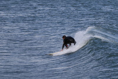 Full length of man in sea surfing