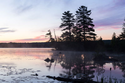 Mist rising from lovering lake during an early summer morning, magog, eastern townships, quebec