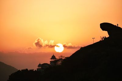 Silhouette of building against sky during sunset
