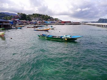 Boats in sea against sky