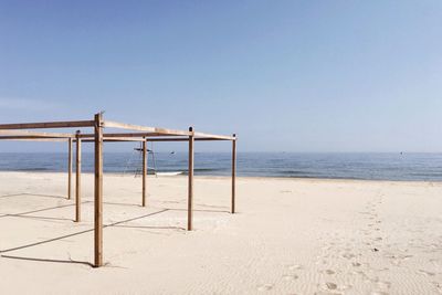 Lifeguard hut on beach against clear sky