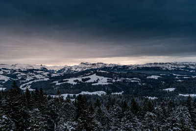 Scenic view of snowcapped mountains against sky during winter