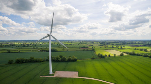 Windmill on field against sky