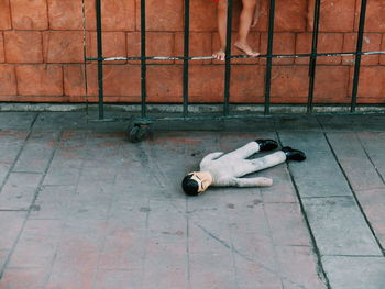 Low section of a boy with abandoned stuffed toy