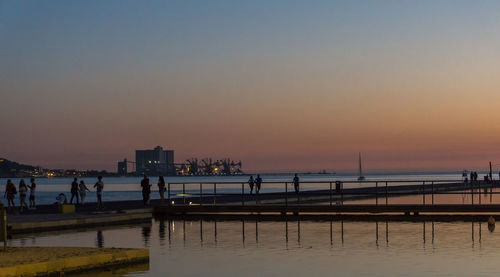 Scenic view of sea against clear sky at sunset