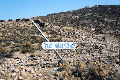 Information sign on road against clear sky