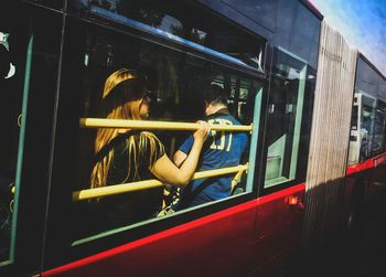 Rear view of woman sitting in bus