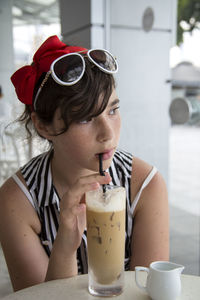 Young woman holding cup