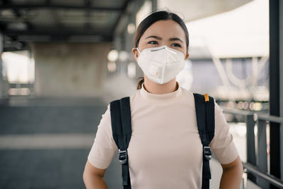 Portrait of woman wearing gas mask in corridor