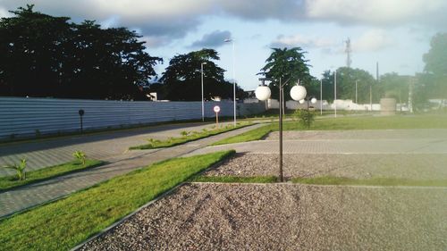 Empty road with trees in background