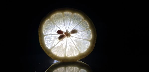 Close-up of lemon slice against black background