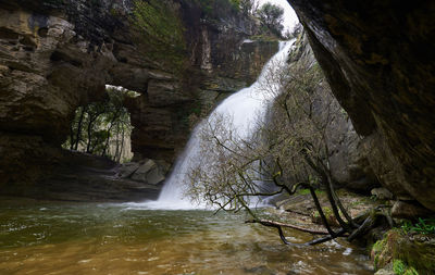 Stream flowing through rocks in forest