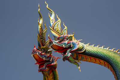 Low angle view of statue of temple against sky