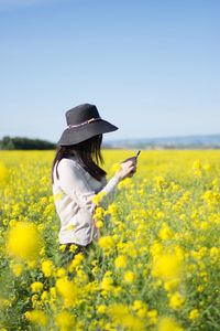 Woman standing in flower field