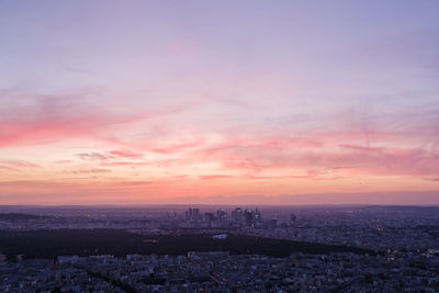 Aerial view of buildings against sky during sunset