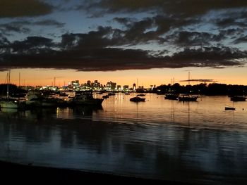 Sailboats in marina at sunset