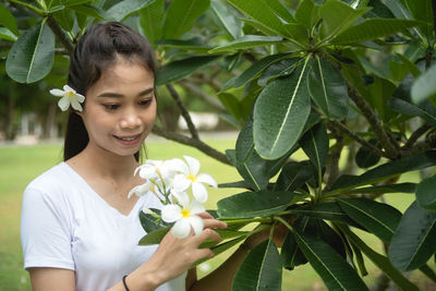 Low section of woman with pink flowers