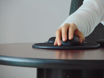 Close-up of person using laptop on table