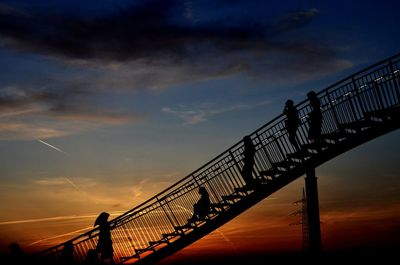 Silhouette bridge against sky during sunset