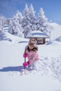 Woman skiing on snow covered field