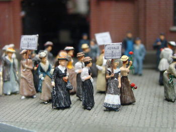 Close-up of figurines on table by street in city