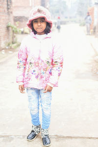 Portrait of smiling girl standing on road