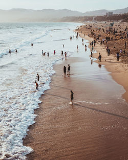 High angle view of people at beach during sunset