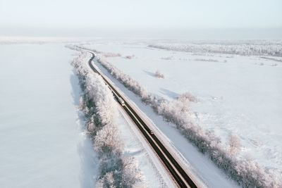 Aerial view of snow covered landscape against sky