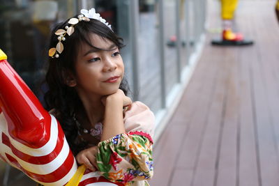 Portrait of young woman sitting outdoors