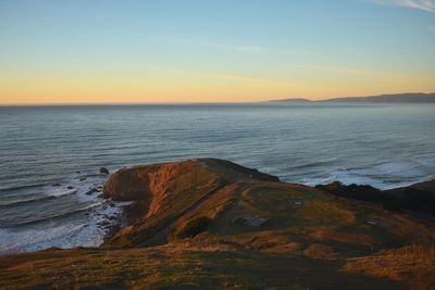 Scenic view of sea against clear sky during sunset