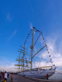 Low angle view of sailboat against blue sky