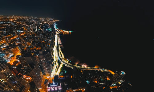 High angle view of illuminated city buildings at night