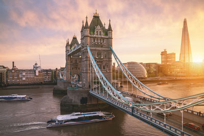 Tower bridge over thames river during sunset in city