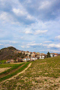 Houses on field against sky