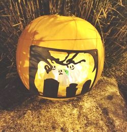 Close-up of pumpkin on stone wall during halloween