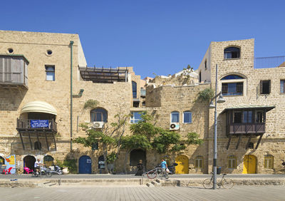 Buildings against clear blue sky in city