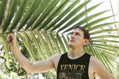 Full length of young man with palm tree