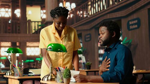 Male friends using mobile phone in restaurant