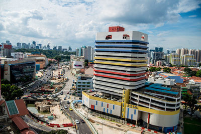 View of cityscape against cloudy sky