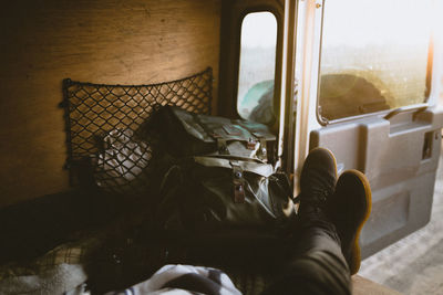 Low section of man with backpack in bus