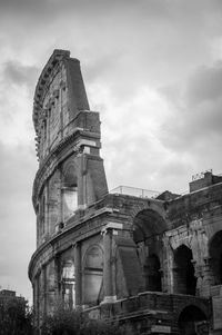 Low angle view of old building against cloudy sky