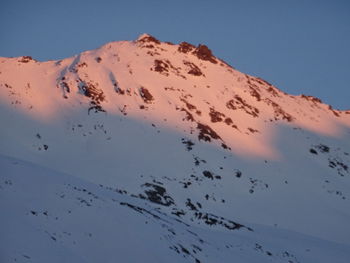 Scenic view of snowcapped mountains against clear sky