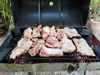 High angle view of meat on barbecue grill