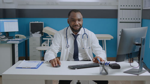 Portrait of smiling doctor working at clinic