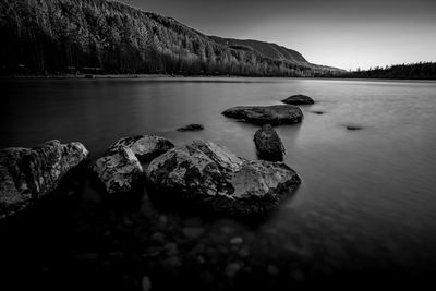 Scenic view of rocks in lake against sky