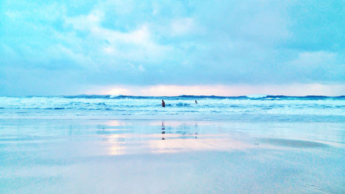 Scenic view of sea against cloudy sky