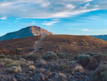 Scenic view of arid landscape against sky