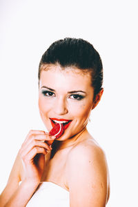 Portrait of young woman with red hair against white background