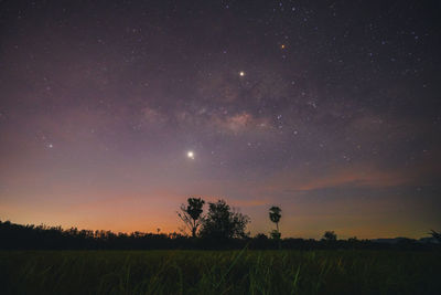 Scenic view of field against sky at night