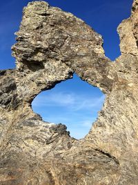 Low angle view of rock formation against sky